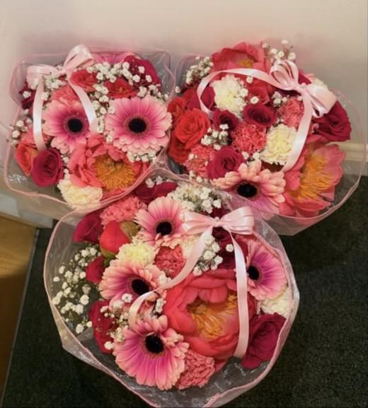 Three hand-tied bouquets with pink gerberas, coral peonies, roses and carnations